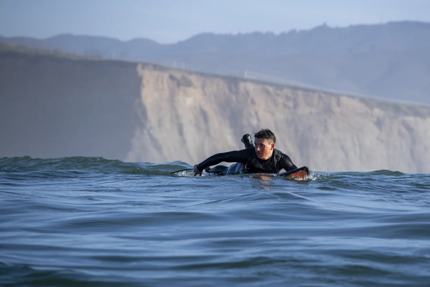 Jack Snyder taking a late drop at Mavericks, bespoke big wave surf photography.