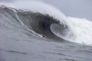 Surfer riding a large wave in the ocean