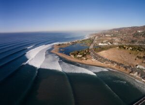 Coastal landscape with waves, beach, and road