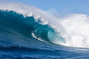 Surfer riding a large wave in the ocean