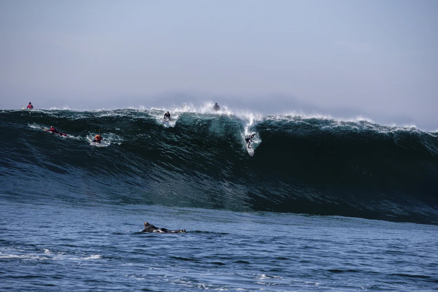 Luca Padua carving a massive Mavericks face, premium ocean wall art.
