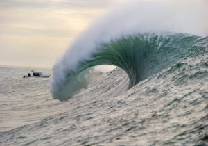 A high-definition photograph of a large ocean wave about to crash, displayed as a print with a contemporary look.