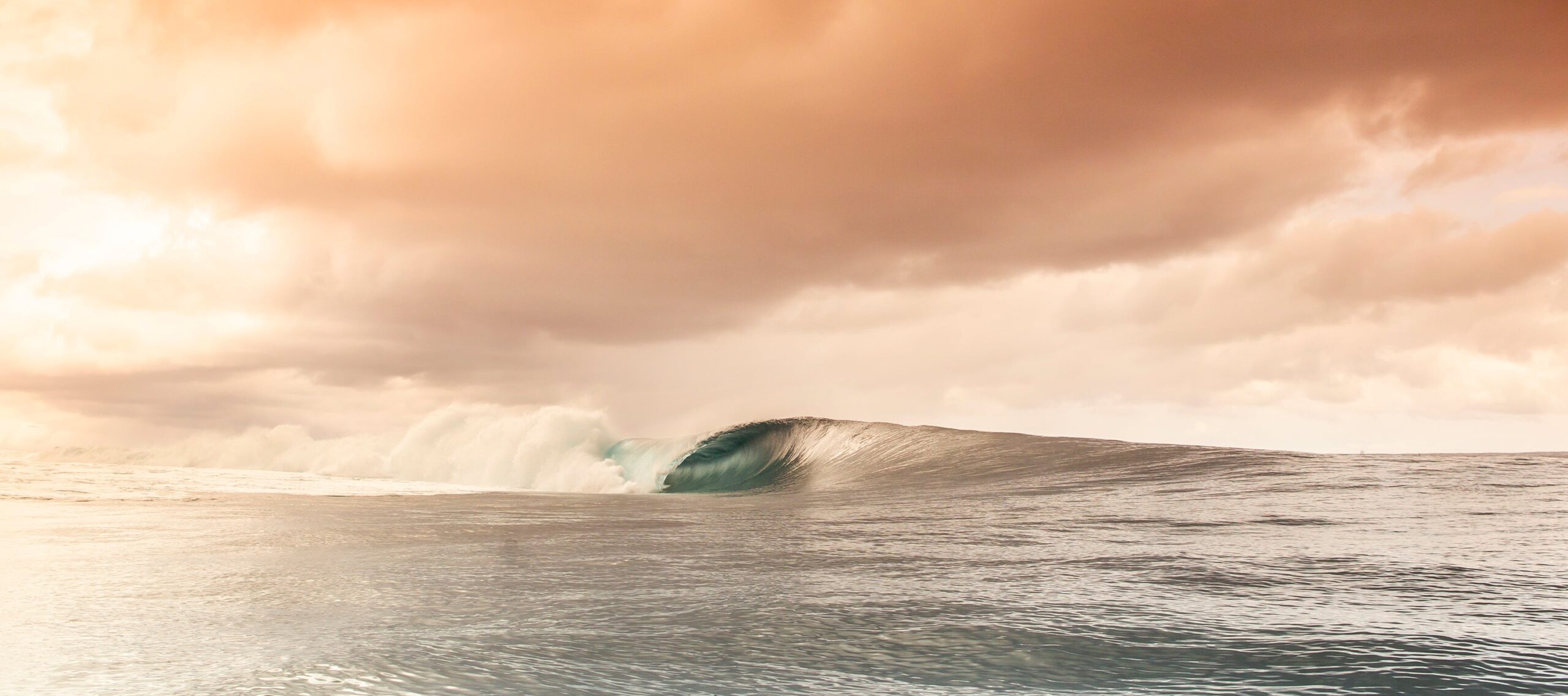 Luxury wall fine art of a solitary panoramic barrel wave curling over a pristine reef at sunset, high-end ocean photography by Fred Pompermayer.