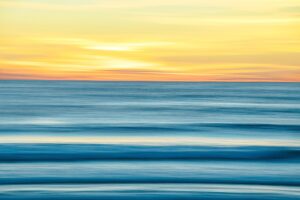 Abstract seascape with blurred water and sky at sunset.