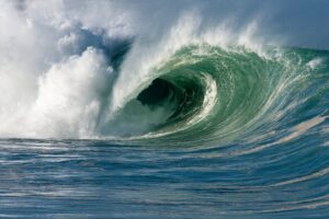 Towering wave with a curling crest in the ocean