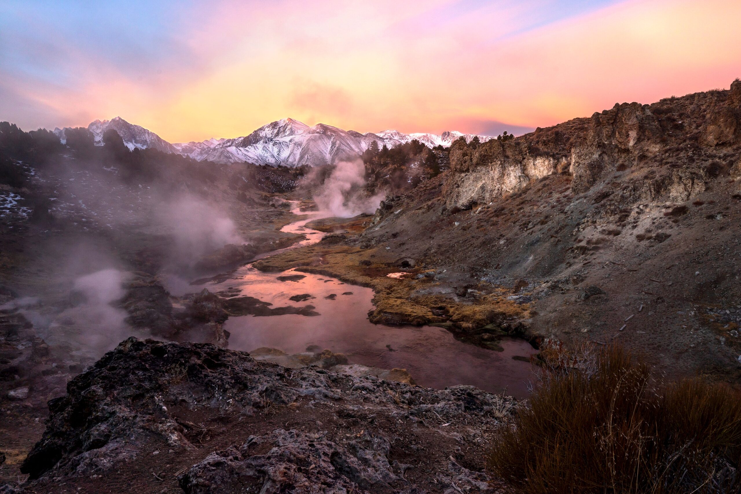 Grand View wall fine art of snow mountains in the High Sierra at sunrise with steaming hot springs and a carving river, museum-quality mountain landscape photography.
