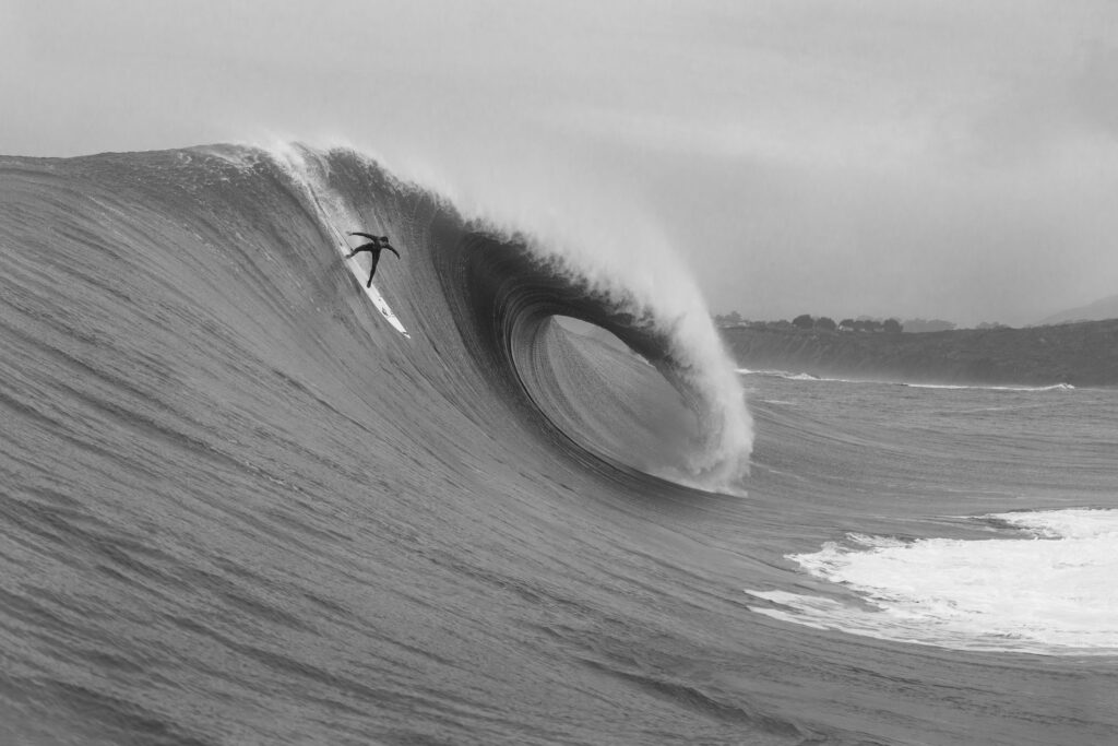 Iconic black and white photography of Jamie Mitchell dropping into a massive, vertical wall of water at Mavericks, California. | Biggest Wave Ever Surfed 2014: Jamie Mitchell Mavericks | Wall Fine Art