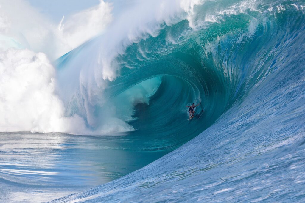 Koa Rothman inside a massive sapphire barrel at Teahupo’o, Tahiti, during the 2013 Code Red 2 swell, captured by Fred Pompermayer.