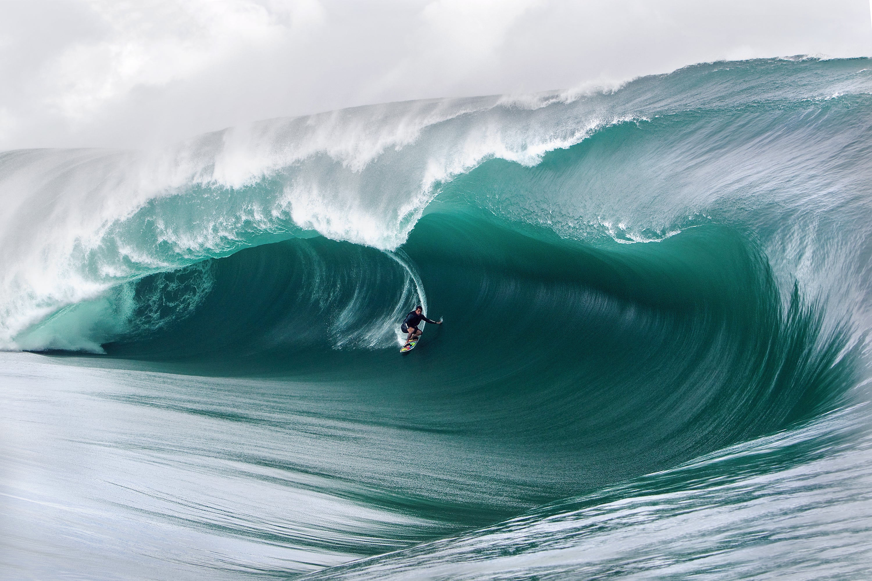 Pato Teixeira deep inside a massive, emerald-green barrel during the historic Code Red swell at Teahupo’o, Tahiti