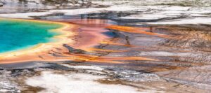 Luxury wall fine art of Yellowstone National Park Grand Prismatic Spring, featuring vibrant orange and turquoise geothermal textures, panoramic photography by Fred Pompermayer.